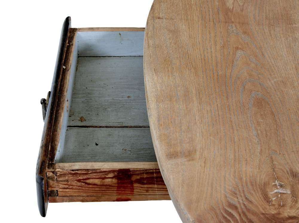 A rustic 19th-century circular occasional table featuring a natural wood top, a dark painted base with a single drawer, turned legs, and an X-shaped cross-stretcher. View VIII