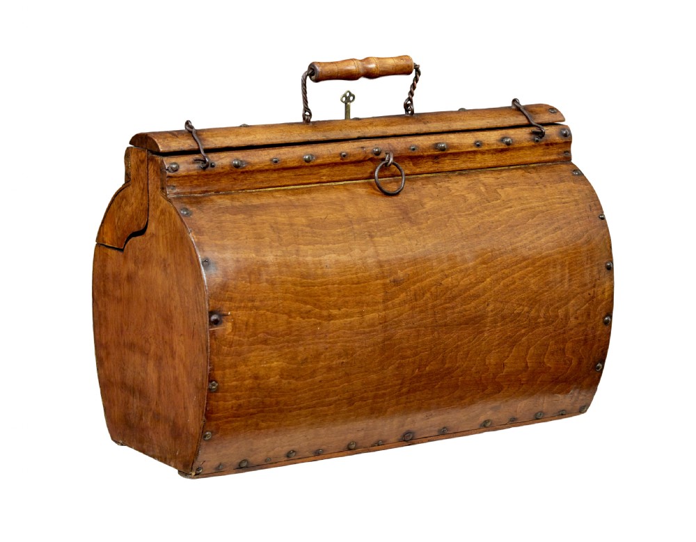 An early 20th-century Scandinavian wooden doctors bag featuring a curved timber body reinforced with iron rivets, a brass lock, and a turned wooden carry handle.