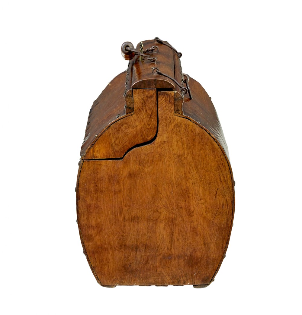 An early 20th-century Scandinavian wooden doctors bag featuring a curved timber body reinforced with iron rivets, a brass lock, and a turned wooden carry handle. View V