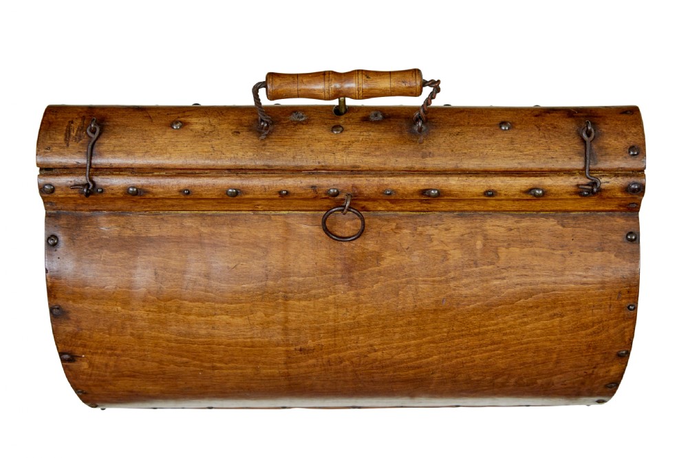 An early 20th-century Scandinavian wooden doctors bag featuring a curved timber body reinforced with iron rivets, a brass lock, and a turned wooden carry handle. View VI