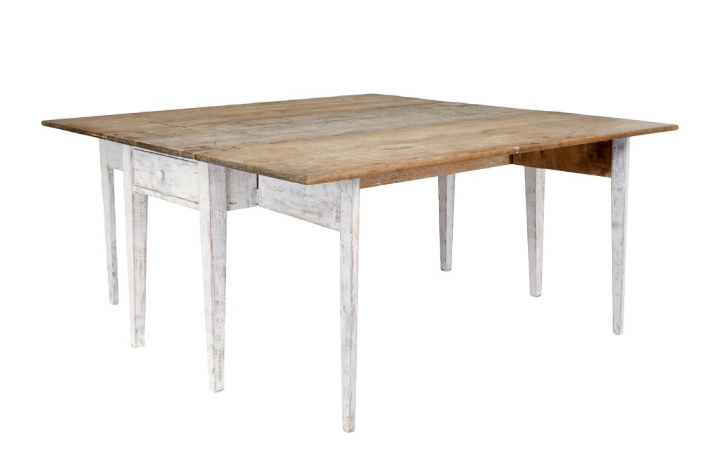 A 19th-century pine drop-leaf kitchen table featuring a natural wood top, hinged side flaps, end drawer, and a white-painted base with tapered square legs. View III