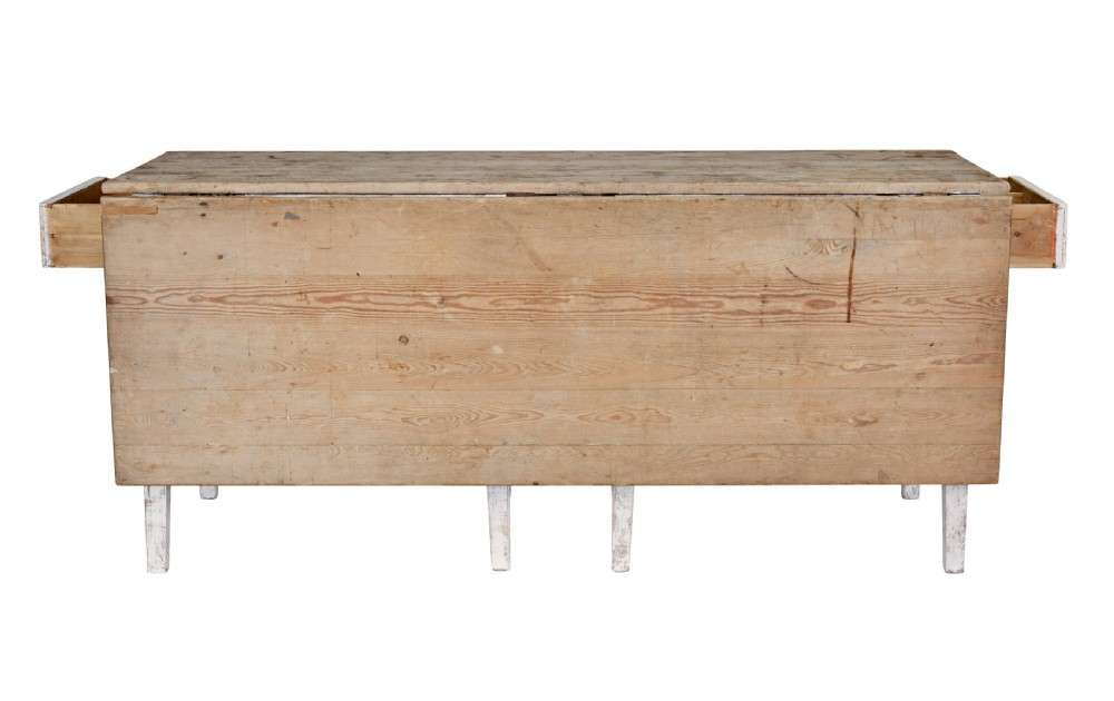 A 19th-century pine drop-leaf kitchen table featuring a natural wood top, hinged side flaps, end drawer, and a white-painted base with tapered square legs. View V