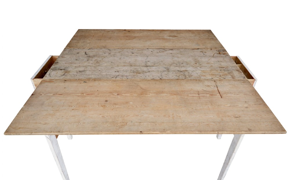 A 19th-century pine drop-leaf kitchen table featuring a natural wood top, hinged side flaps, end drawer, and a white-painted base with tapered square legs. View VII