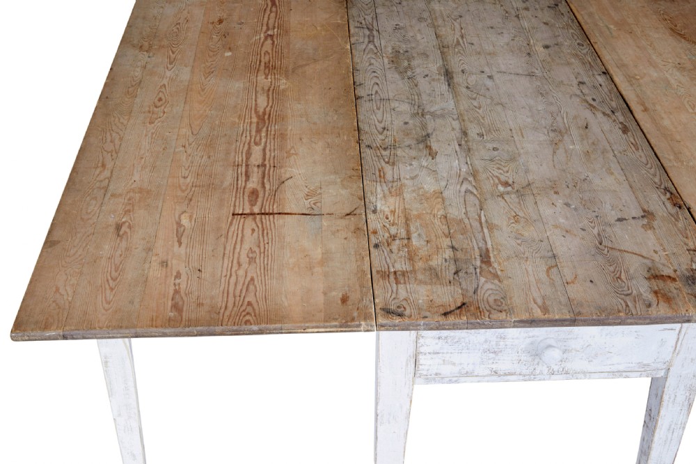 A 19th-century pine drop-leaf kitchen table featuring a natural wood top, hinged side flaps, end drawer, and a white-painted base with tapered square legs. View VIII