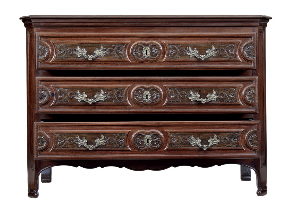 A 19th-century French Provincial walnut commode featuring three long carved drawers with brass handles and a scalloped lower apron. View III
