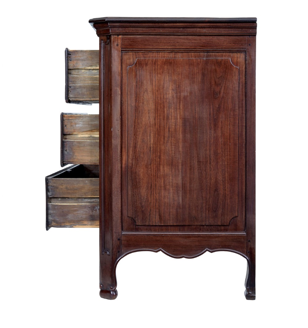 A 19th-century French Provincial walnut commode featuring three long carved drawers with brass handles and a scalloped lower apron. View V