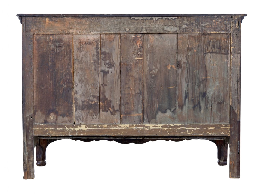 A 19th-century French Provincial walnut commode featuring three long carved drawers with brass handles and a scalloped lower apron. View VI
