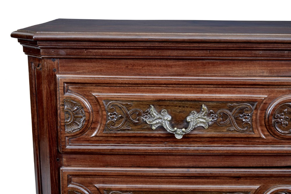 A 19th-century French Provincial walnut commode featuring three long carved drawers with brass handles and a scalloped lower apron. View VIII