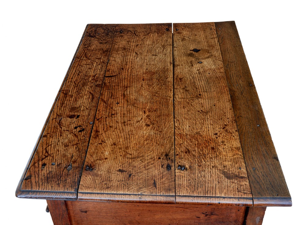 An early 18th-century Georgian oak side table featuring two drawers with brass drop handles, keyhole escutcheons, turned legs, and a box stretcher. View II