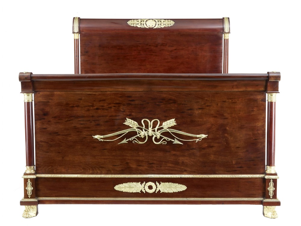 A five-piece nineteenth-century French Empire Revival mahogany bedroom suite featuring gilt bronze mounts, including a sleigh bed, a three-door mirrored wardrobe, a dressing table with mirror, and two matching bedside cabinets. View II