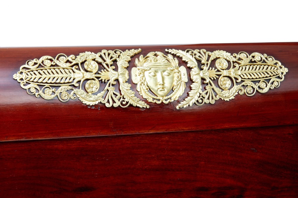 A five-piece nineteenth-century French Empire Revival mahogany bedroom suite featuring gilt bronze mounts, including a sleigh bed, a three-door mirrored wardrobe, a dressing table with mirror, and two matching bedside cabinets. View VIII