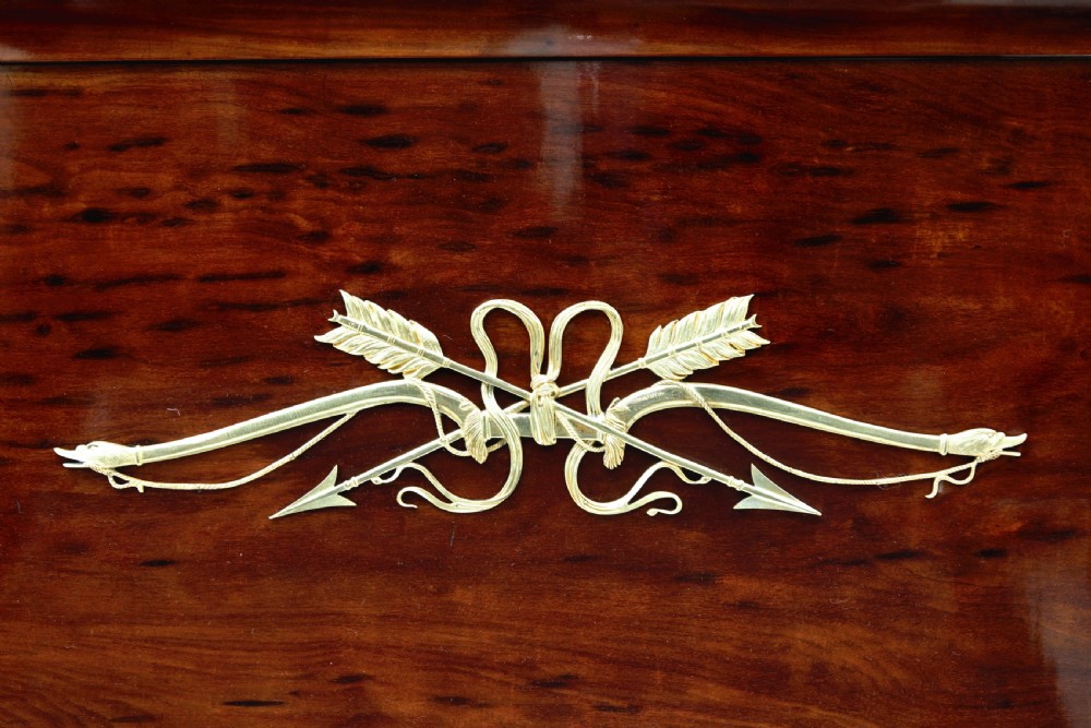 A five-piece nineteenth-century French Empire Revival mahogany bedroom suite featuring gilt bronze mounts, including a sleigh bed, a three-door mirrored wardrobe, a dressing table with mirror, and two matching bedside cabinets. View IX