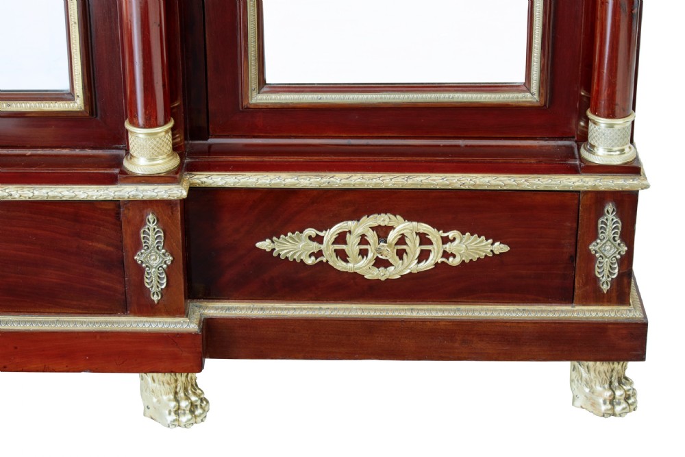 A five-piece nineteenth-century French Empire Revival mahogany bedroom suite featuring gilt bronze mounts, including a sleigh bed, a three-door mirrored wardrobe, a dressing table with mirror, and two matching bedside cabinets. View XIII
