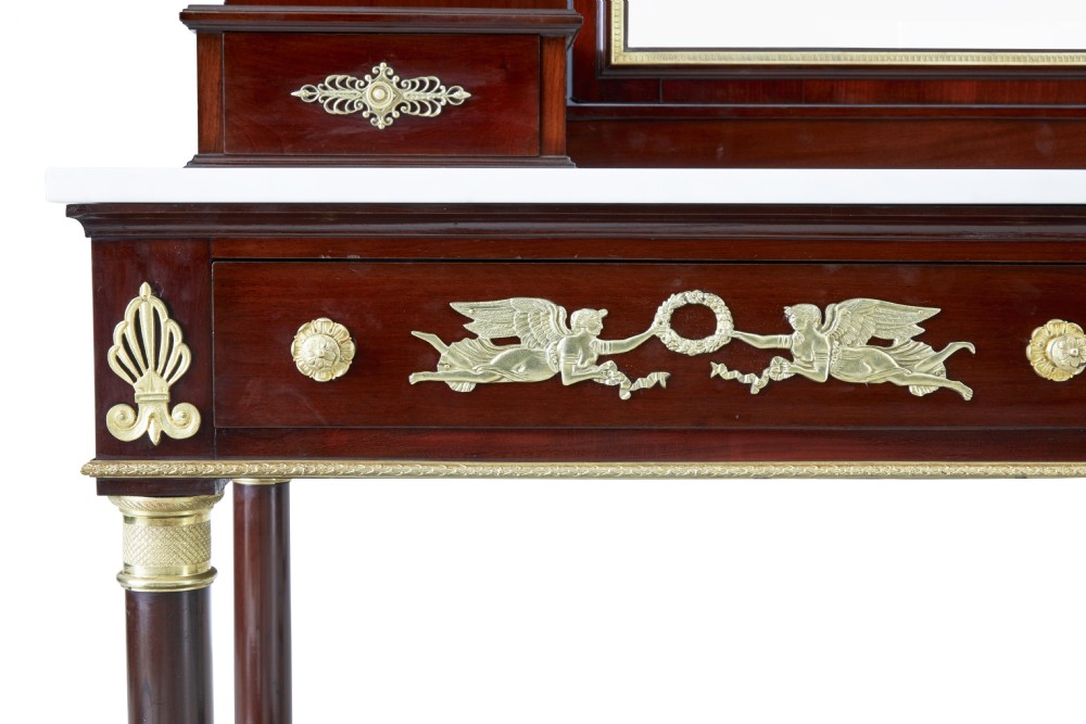 A five-piece nineteenth-century French Empire Revival mahogany bedroom suite featuring gilt bronze mounts, including a sleigh bed, a three-door mirrored wardrobe, a dressing table with mirror, and two matching bedside cabinets. View XXII