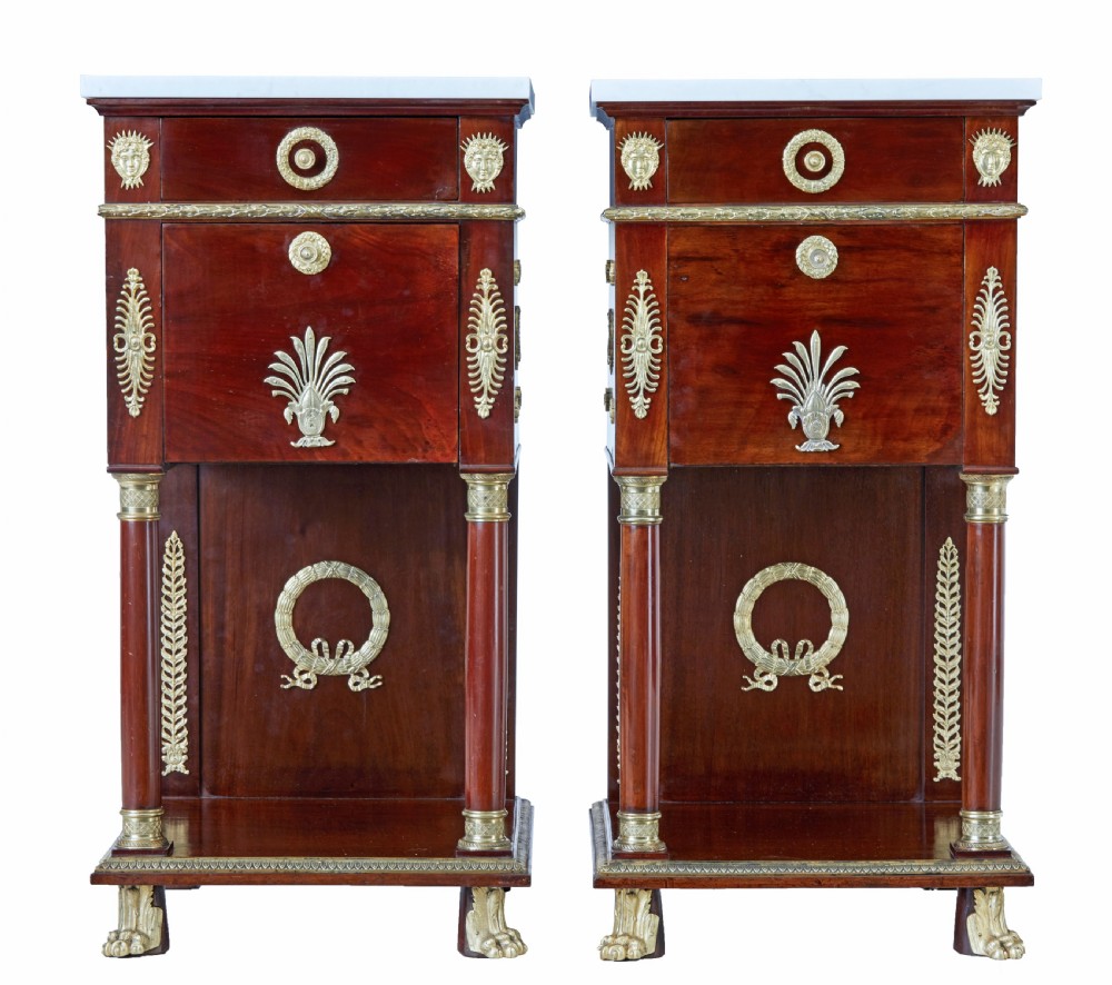 A five-piece nineteenth-century French Empire Revival mahogany bedroom suite featuring gilt bronze mounts, including a sleigh bed, a three-door mirrored wardrobe, a dressing table with mirror, and two matching bedside cabinets. View XXIII