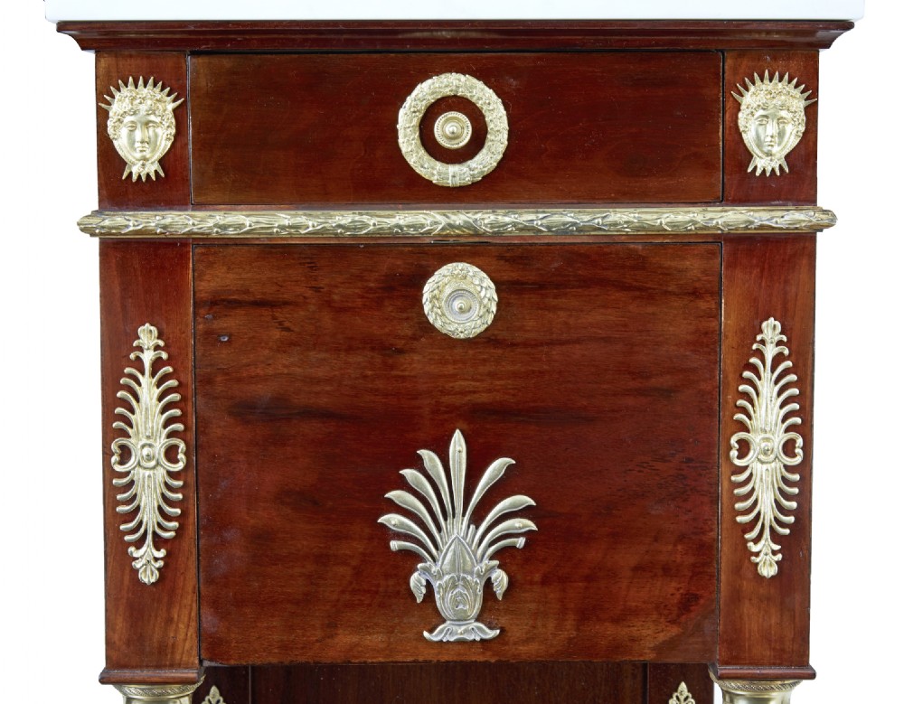 A five-piece nineteenth-century French Empire Revival mahogany bedroom suite featuring gilt bronze mounts, including a sleigh bed, a three-door mirrored wardrobe, a dressing table with mirror, and two matching bedside cabinets. View XXIX