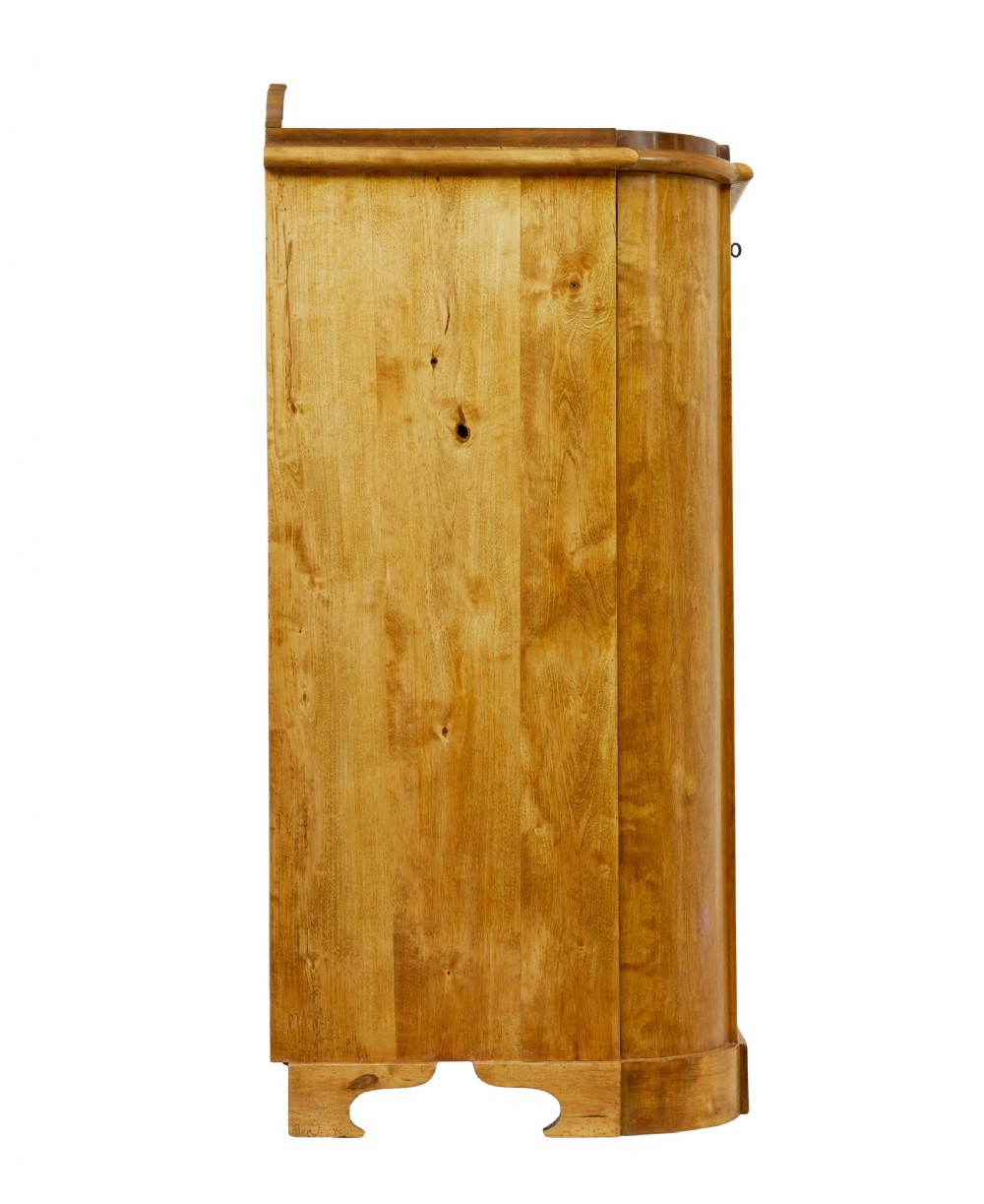 A mid-19th-century Swedish birch buffet sideboard featuring two top drawers, two cabinet doors, and curved side panels in a golden timber finish. View VI