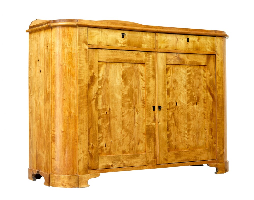 A mid-19th-century Swedish birch buffet sideboard featuring two top drawers, two cabinet doors, and curved side panels in a golden timber finish. View VII