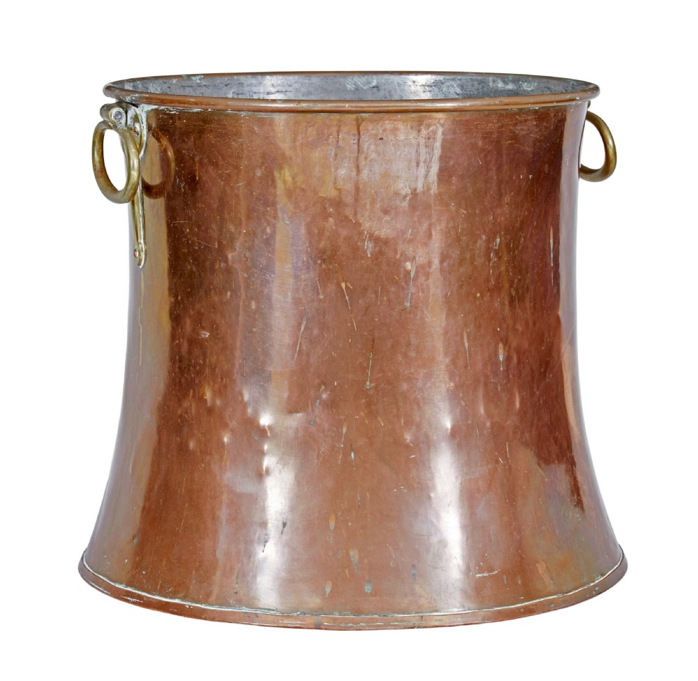 A 19th-century copper log bin featuring a flared, waisted silhouette, rolled rim, and cast brass ring handles. View VI