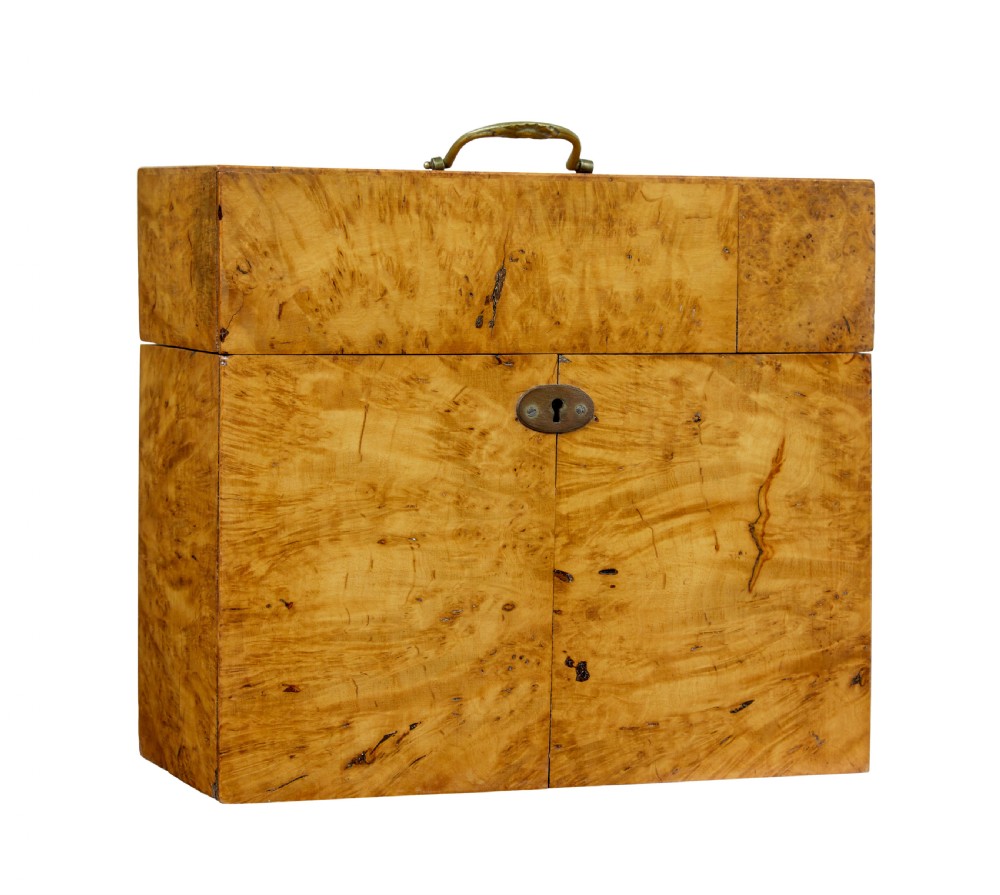 A 19th-century Swedish burr birch table box featuring prominent wood grain patterns, a top brass handle, and an oval brass escutcheon.