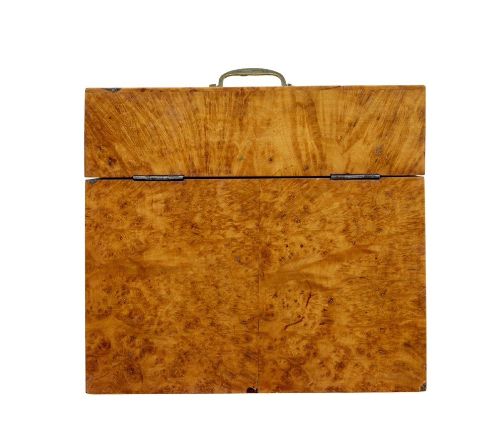 A 19th-century Swedish burr birch table box featuring prominent wood grain patterns, a top brass handle, and an oval brass escutcheon. View V