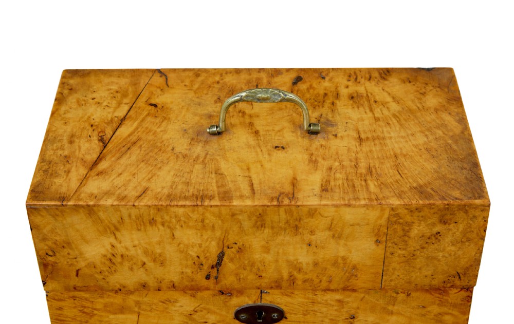 A 19th-century Swedish burr birch table box featuring prominent wood grain patterns, a top brass handle, and an oval brass escutcheon. View VII