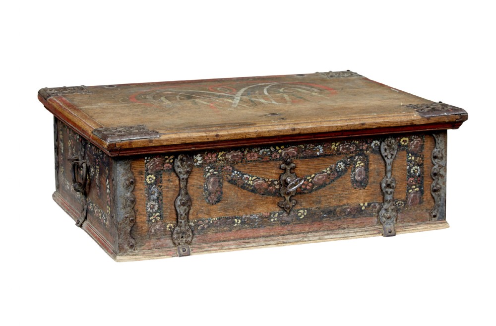 A 19th-century Swedish oak strongbox featuring wrought iron strapwork, side handles, and hand-painted floral motifs on the front panel.