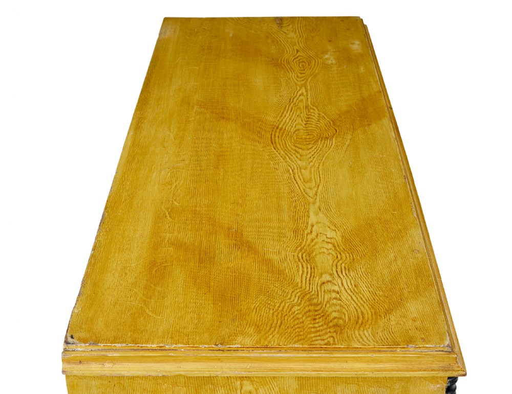 A mid-19th century Swedish northern pine chest of drawers featuring a yellow painted finish, four full-width drawers with black knobs, and black bobbin-turned corner columns. View II