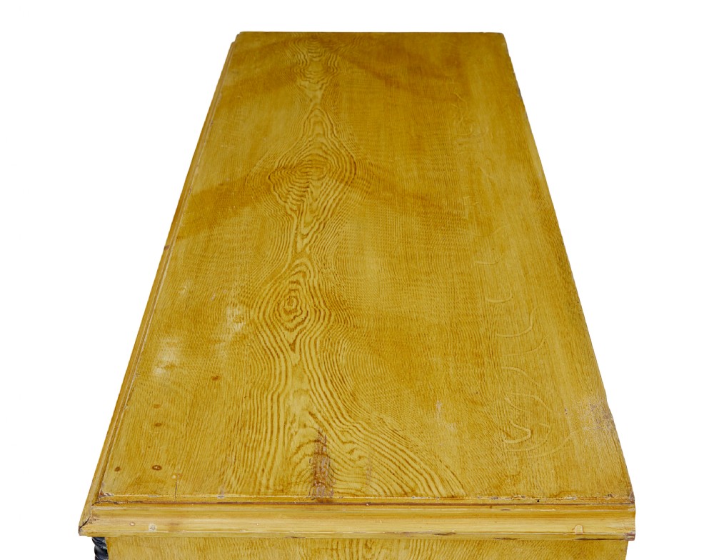 A mid-19th century Swedish northern pine chest of drawers featuring a yellow painted finish, four full-width drawers with black knobs, and black bobbin-turned corner columns. View III