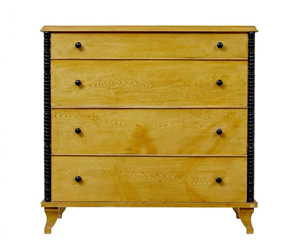 A mid-19th century Swedish northern pine chest of drawers featuring a yellow painted finish, four full-width drawers with black knobs, and black bobbin-turned corner columns. View VII