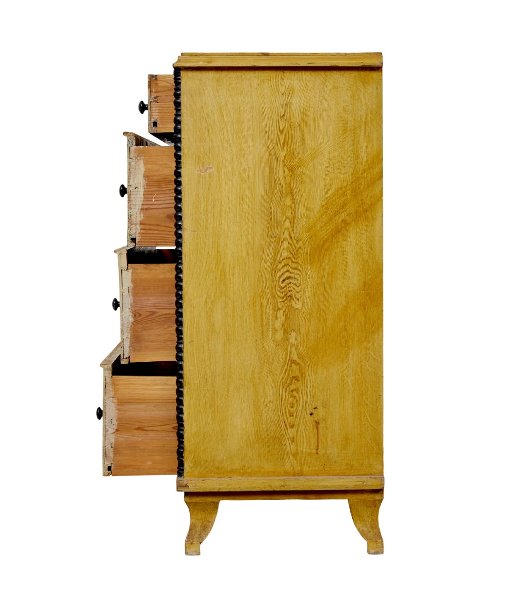 A mid-19th century Swedish northern pine chest of drawers featuring a yellow painted finish, four full-width drawers with black knobs, and black bobbin-turned corner columns. View IX