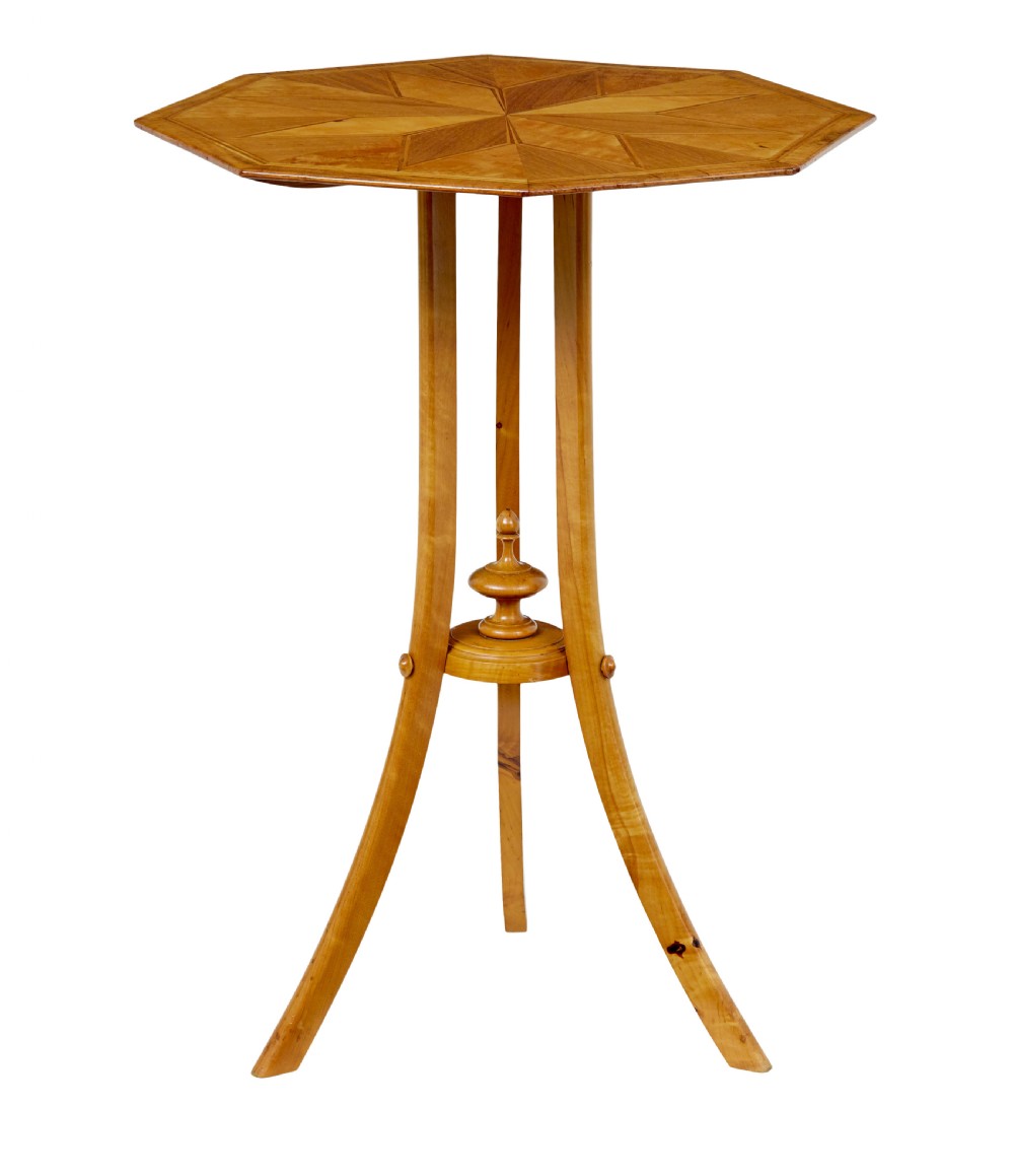 An early 20th-century octagonal occasional table made of light birch wood featuring a geometric starburst inlaid top and splayed legs. View II