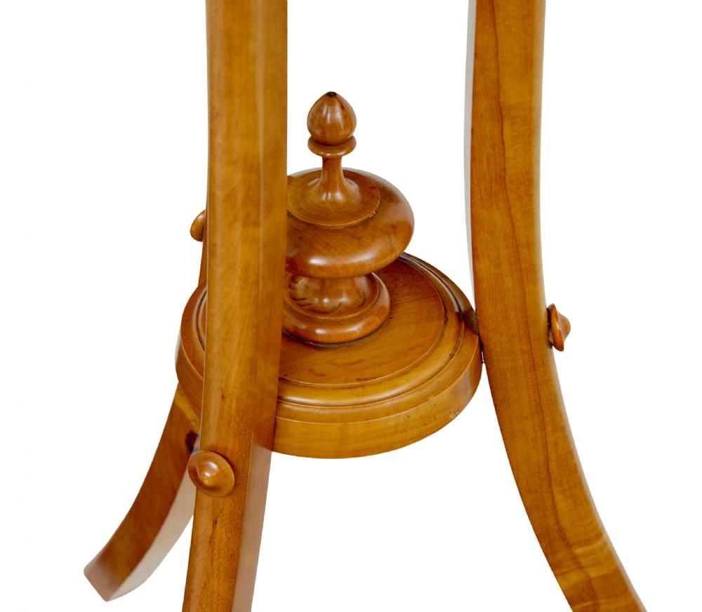 An early 20th-century octagonal occasional table made of light birch wood featuring a geometric starburst inlaid top and splayed legs. View V