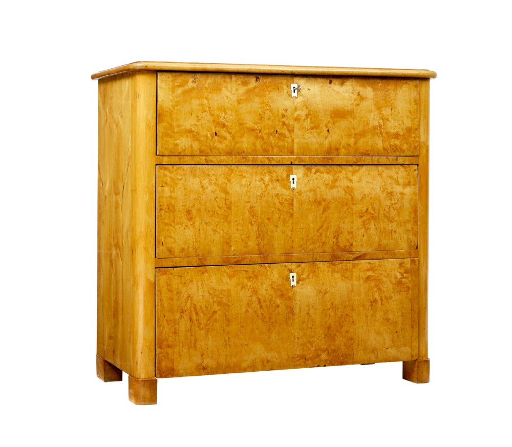 A mid-19th century Swedish birch chest of drawers featuring three full-width drawers with flame grain veneer and rounded side pilasters.