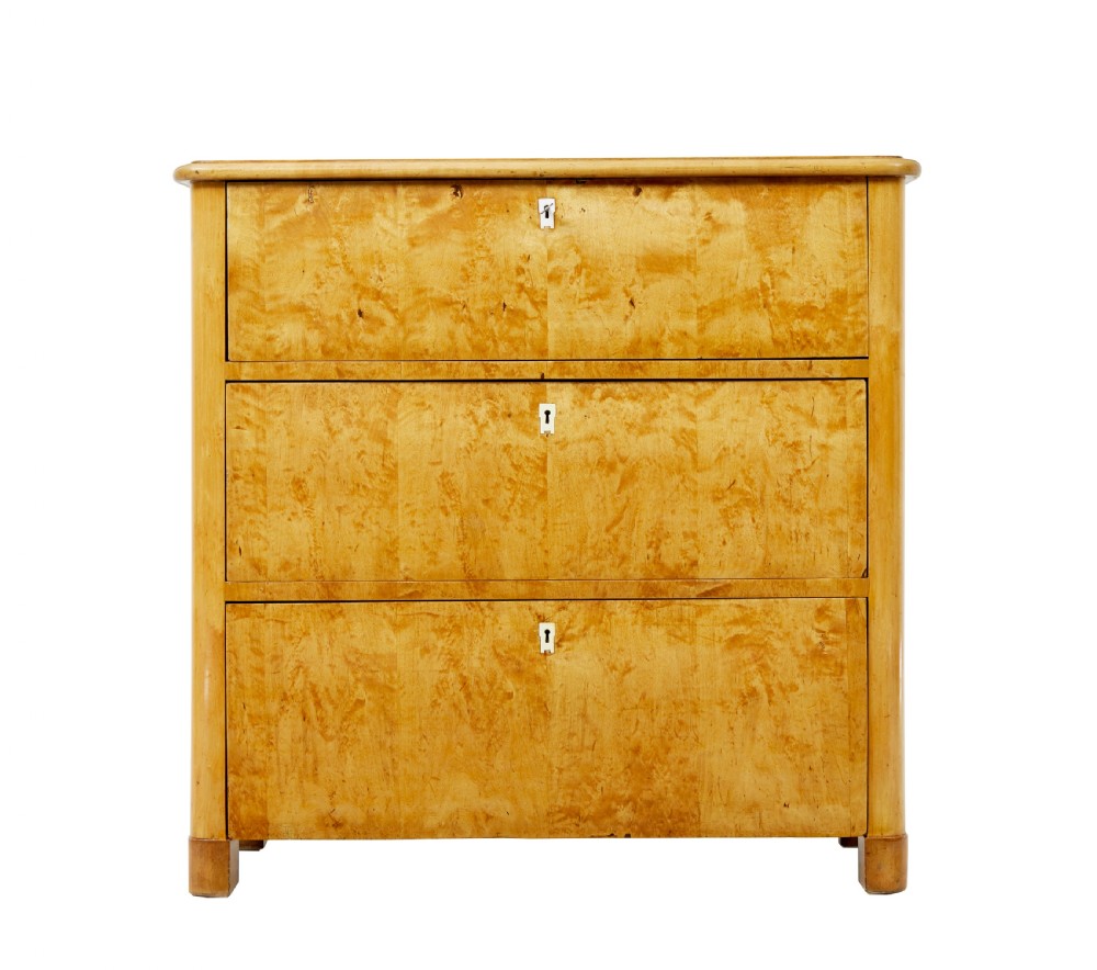 A mid-19th century Swedish birch chest of drawers featuring three full-width drawers with flame grain veneer and rounded side pilasters. View II