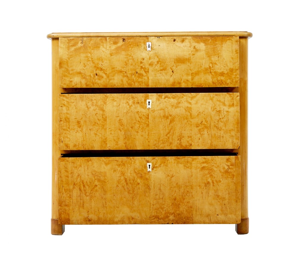 A mid-19th century Swedish birch chest of drawers featuring three full-width drawers with flame grain veneer and rounded side pilasters. View III