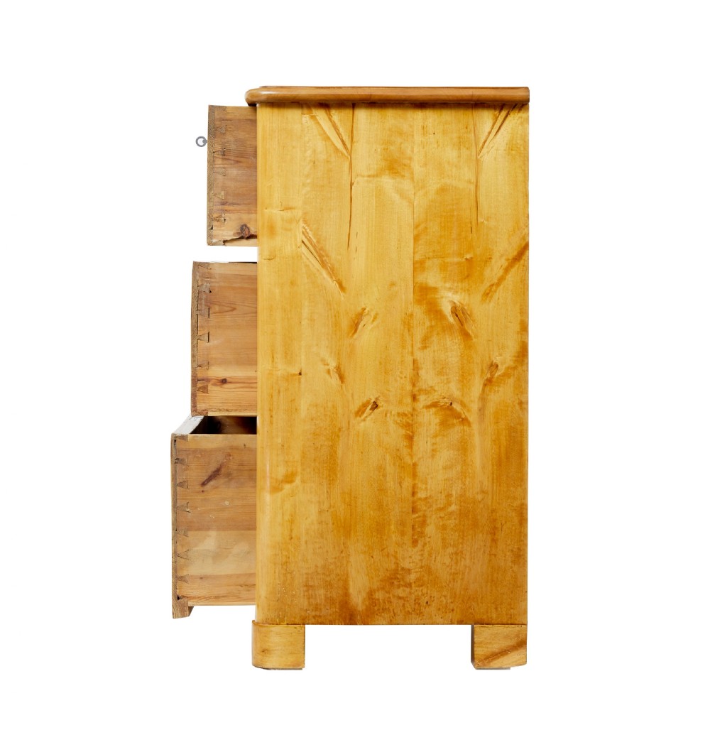 A mid-19th century Swedish birch chest of drawers featuring three full-width drawers with flame grain veneer and rounded side pilasters. View V