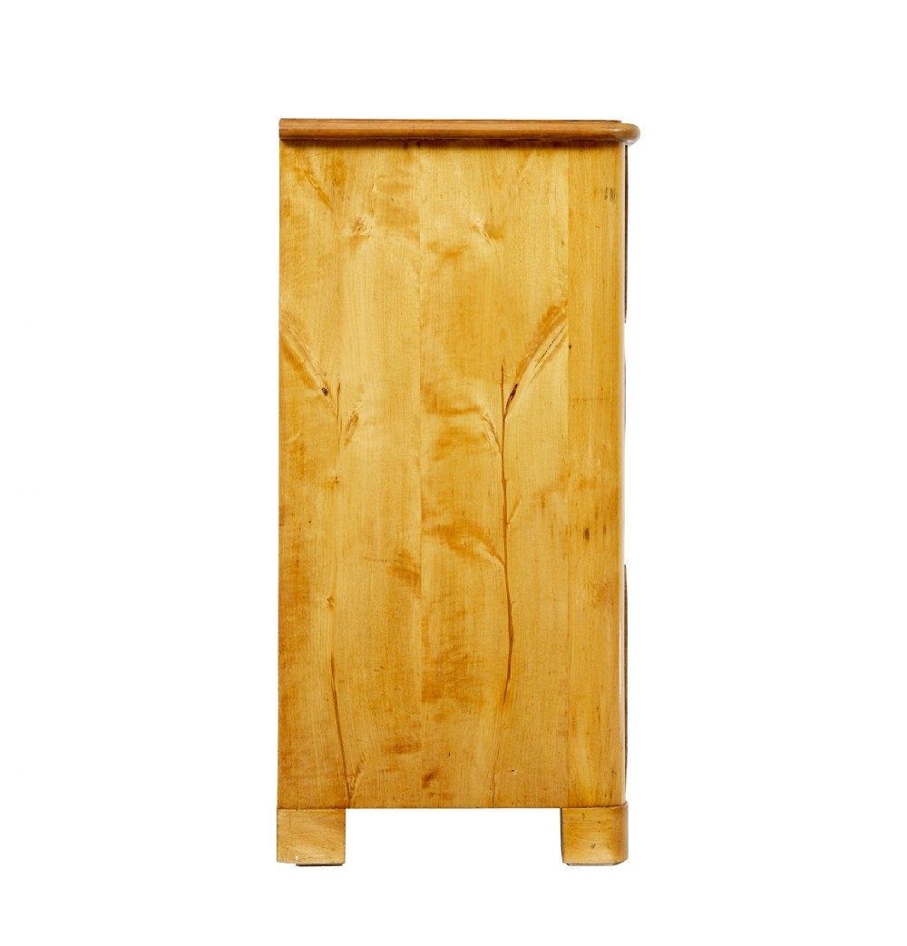 A mid-19th century Swedish birch chest of drawers featuring three full-width drawers with flame grain veneer and rounded side pilasters. View VII