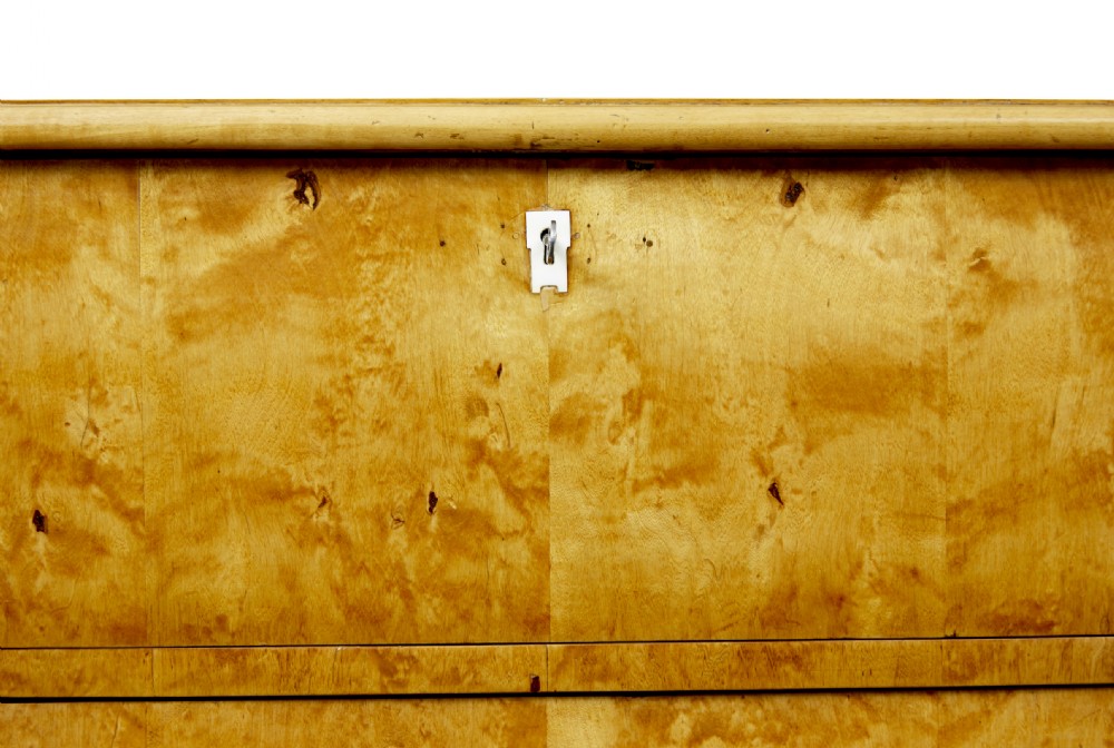A mid-19th century Swedish birch chest of drawers featuring three full-width drawers with flame grain veneer and rounded side pilasters. View VIII