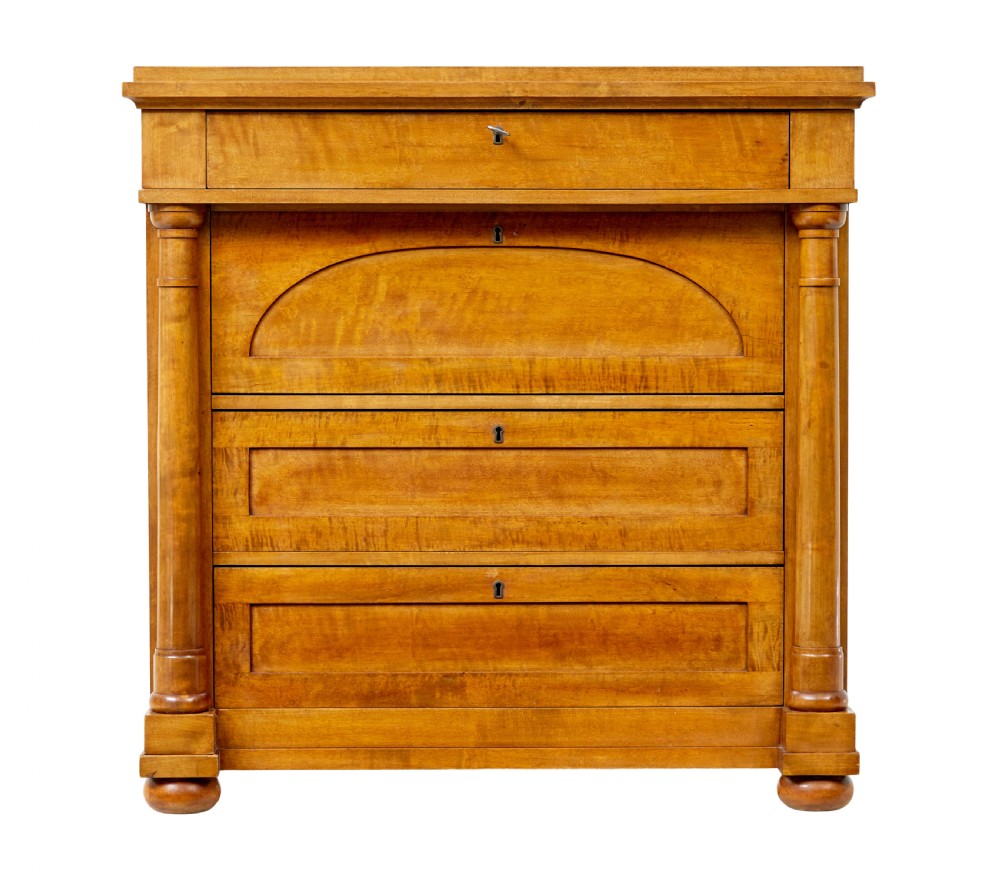 A 19th-century birch Empire Revival chest of drawers featuring architectural side columns, recessed panelled drawers, and turned bun feet. View II