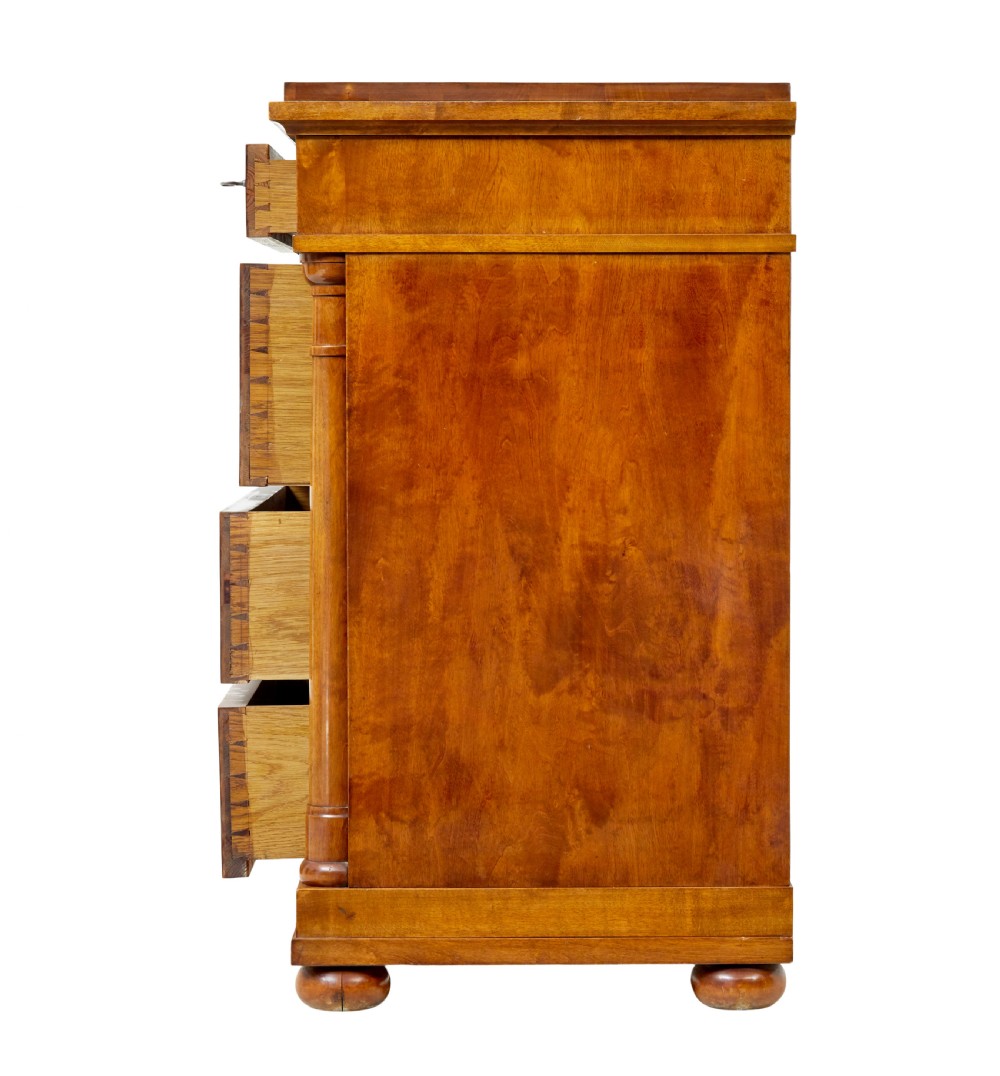 A 19th-century birch Empire Revival chest of drawers featuring architectural side columns, recessed panelled drawers, and turned bun feet. View V