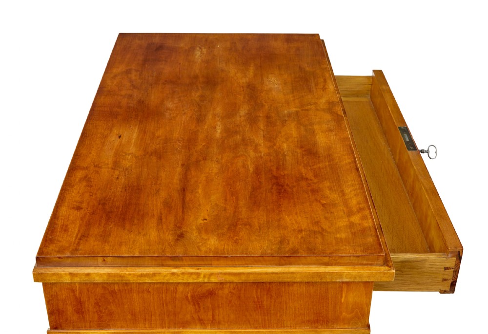 A 19th-century birch Empire Revival chest of drawers featuring architectural side columns, recessed panelled drawers, and turned bun feet. View IX