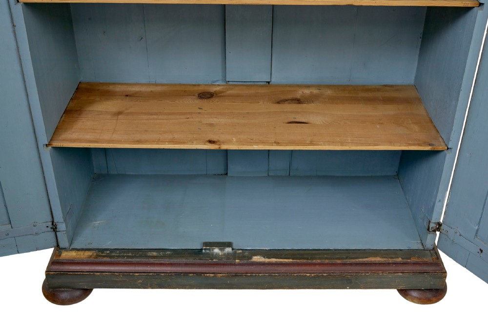 A Swedish hand-painted blue pine cupboard with panelled doors featuring floral motifs, red trim, a dated inscription from 1788, and bun feet. View VIII