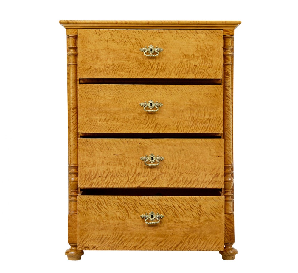 A nineteenth-century Swedish chest of four drawers crafted from figure-rich tiger birch with turned side columns and ornate brass escutcheons. View III