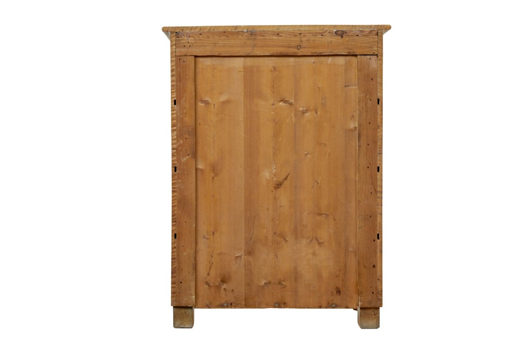 A nineteenth-century Swedish chest of four drawers crafted from figure-rich tiger birch with turned side columns and ornate brass escutcheons. View VI