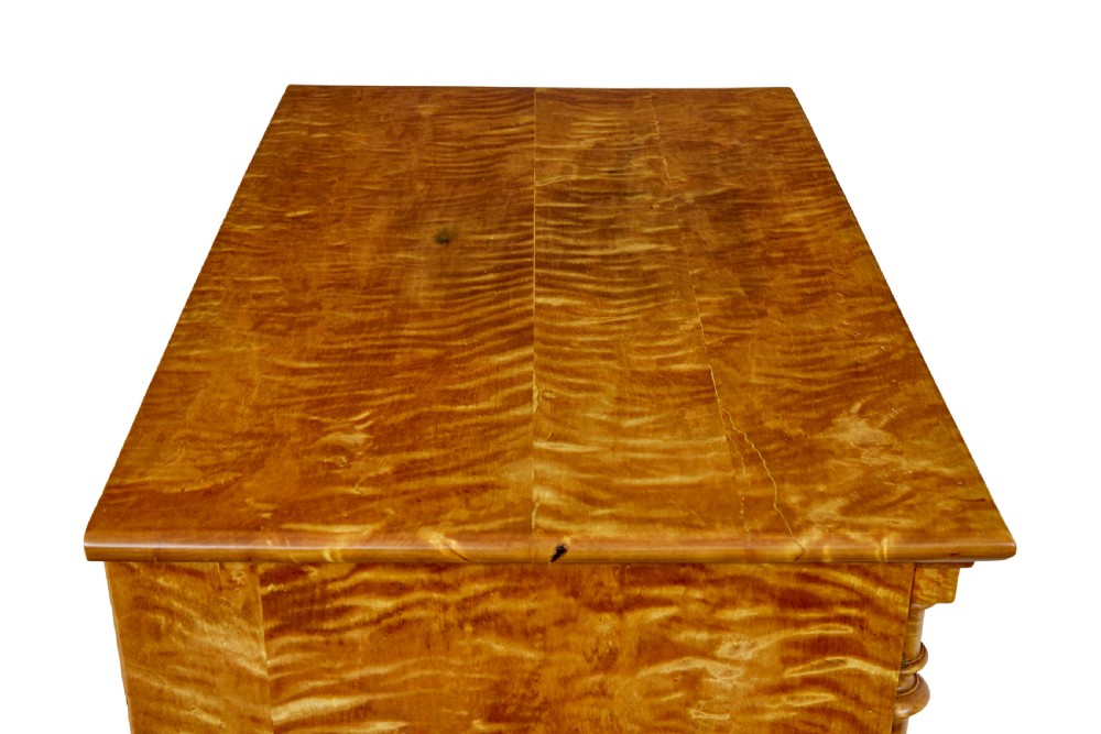 A nineteenth-century Swedish chest of four drawers crafted from figure-rich tiger birch with turned side columns and ornate brass escutcheons. View XI