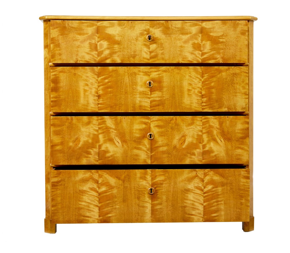 A 19th-century Swedish chest of four drawers crafted from golden flame birch veneer with simple keyhole escutcheons and square legs. View III