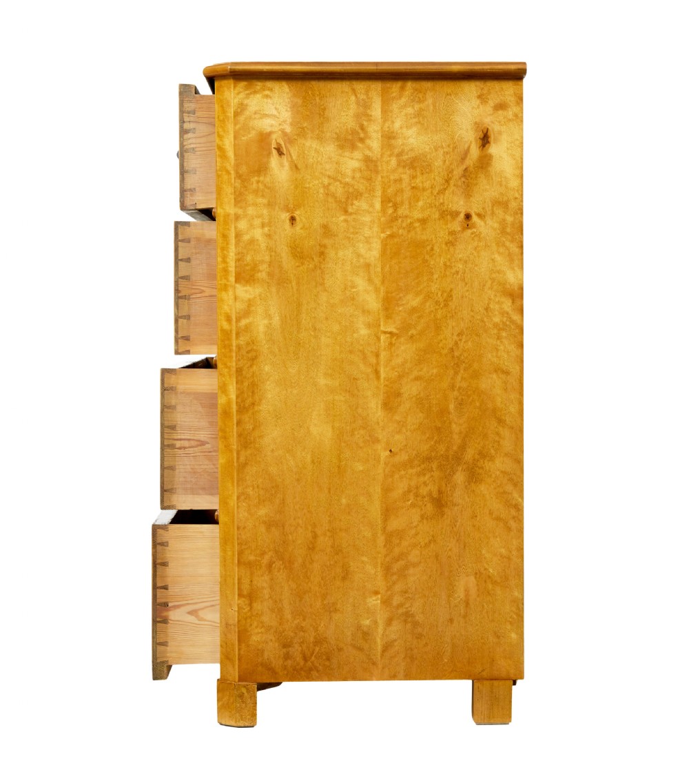 A 19th-century Swedish chest of four drawers crafted from golden flame birch veneer with simple keyhole escutcheons and square legs. View IV