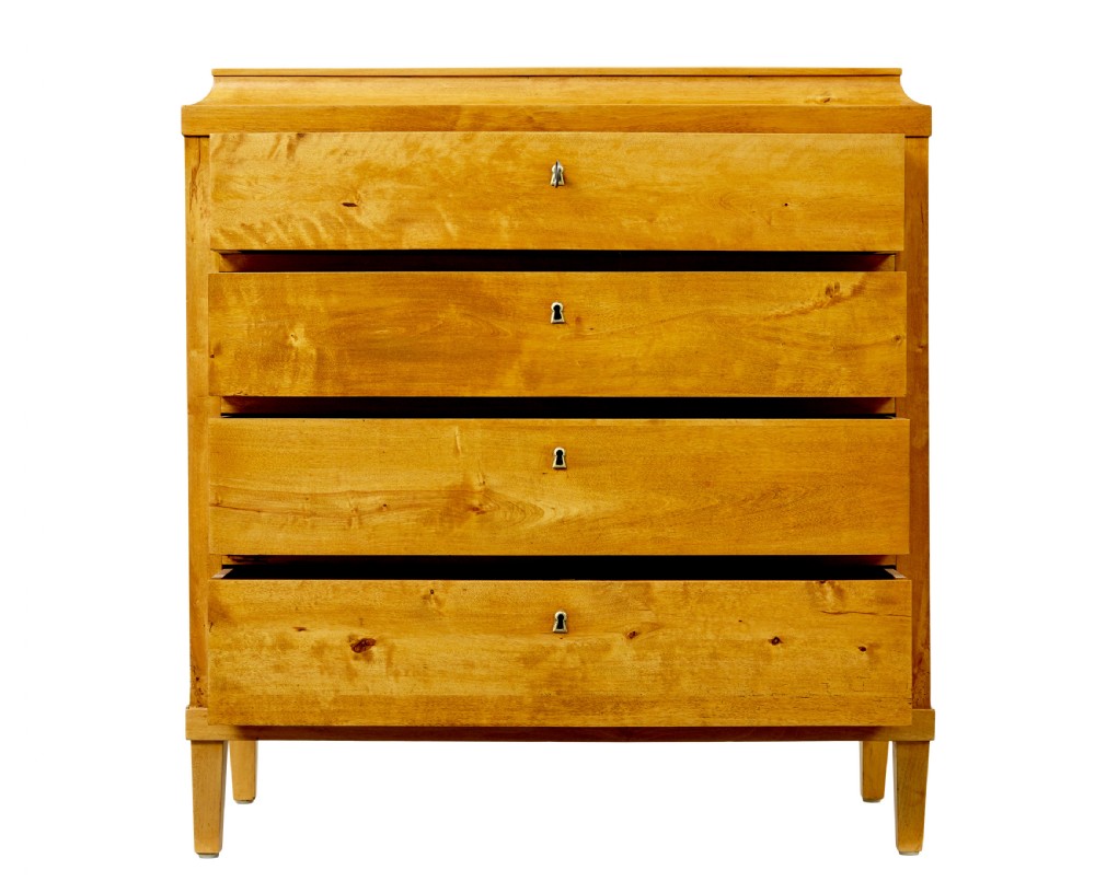 A 19th-century Swedish birch chest featuring four drawers with brass escutcheons, a stepped caddy top moulding, and tapered square legs. View III