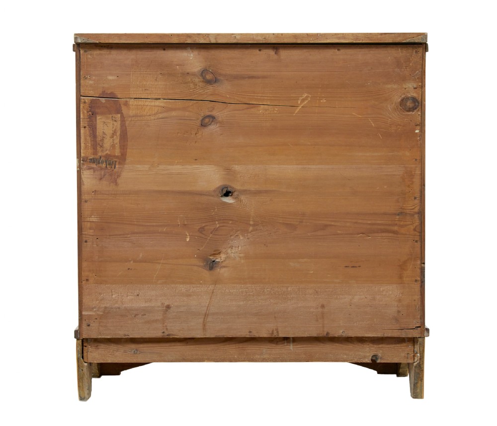 A 19th-century Swedish Empire satin birch chest of drawers featuring three drawers, flanking turned columns, an arched lower veneer panel, and angular block feet. View VI
